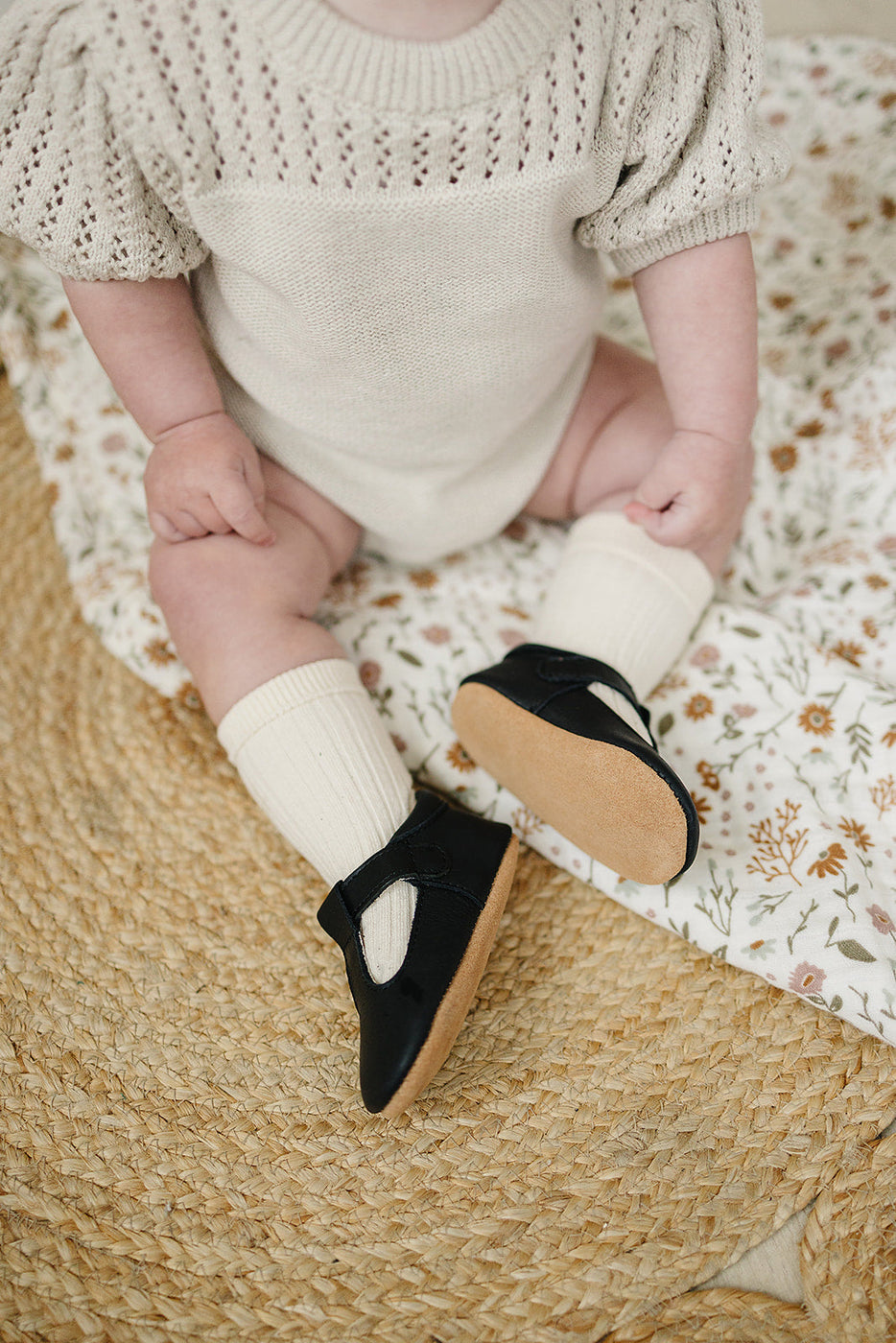 a baby wearing black shoes