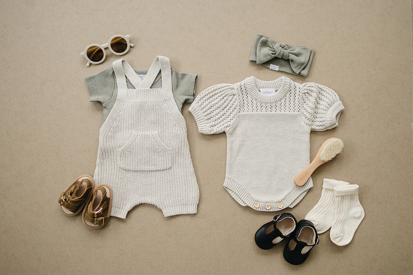 a pair of baby clothes and shoes