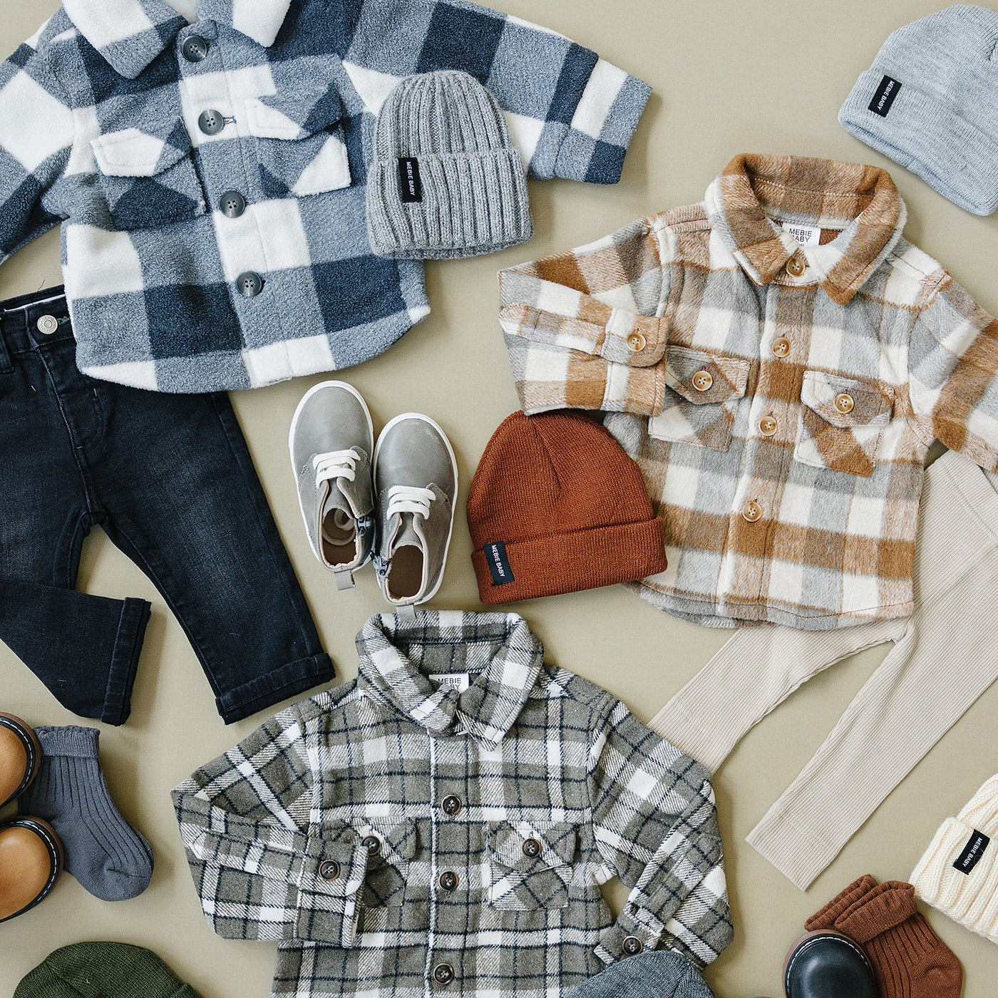 a group of baby clothes and shoes