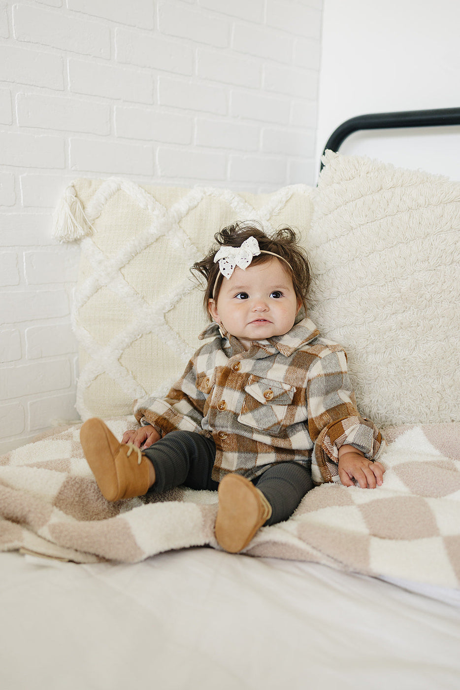 a baby sitting on a blanket