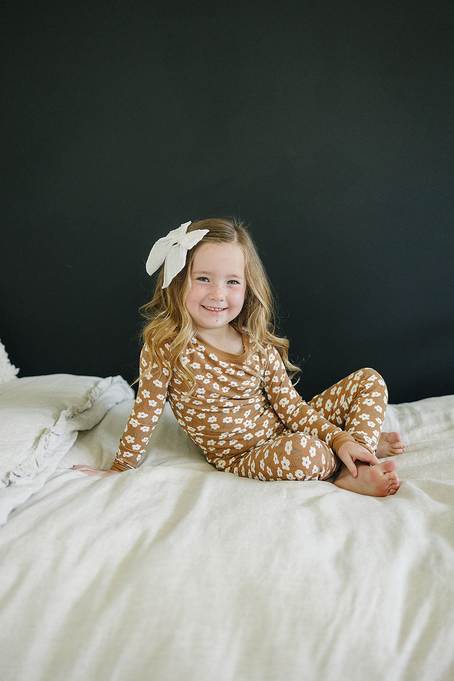 a girl sitting on a bed