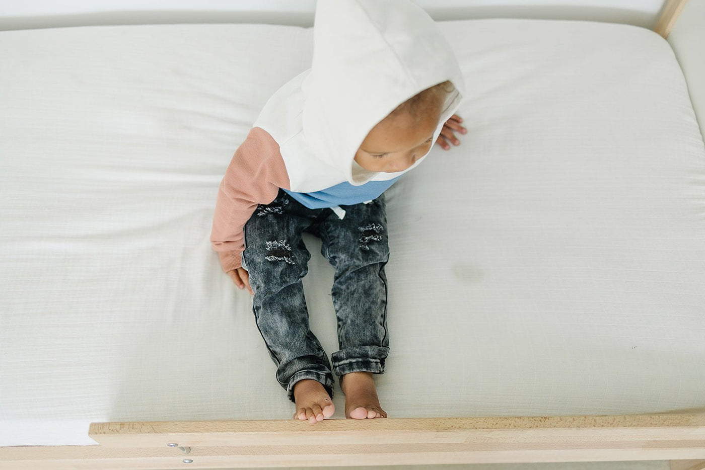 a child sitting on a bed