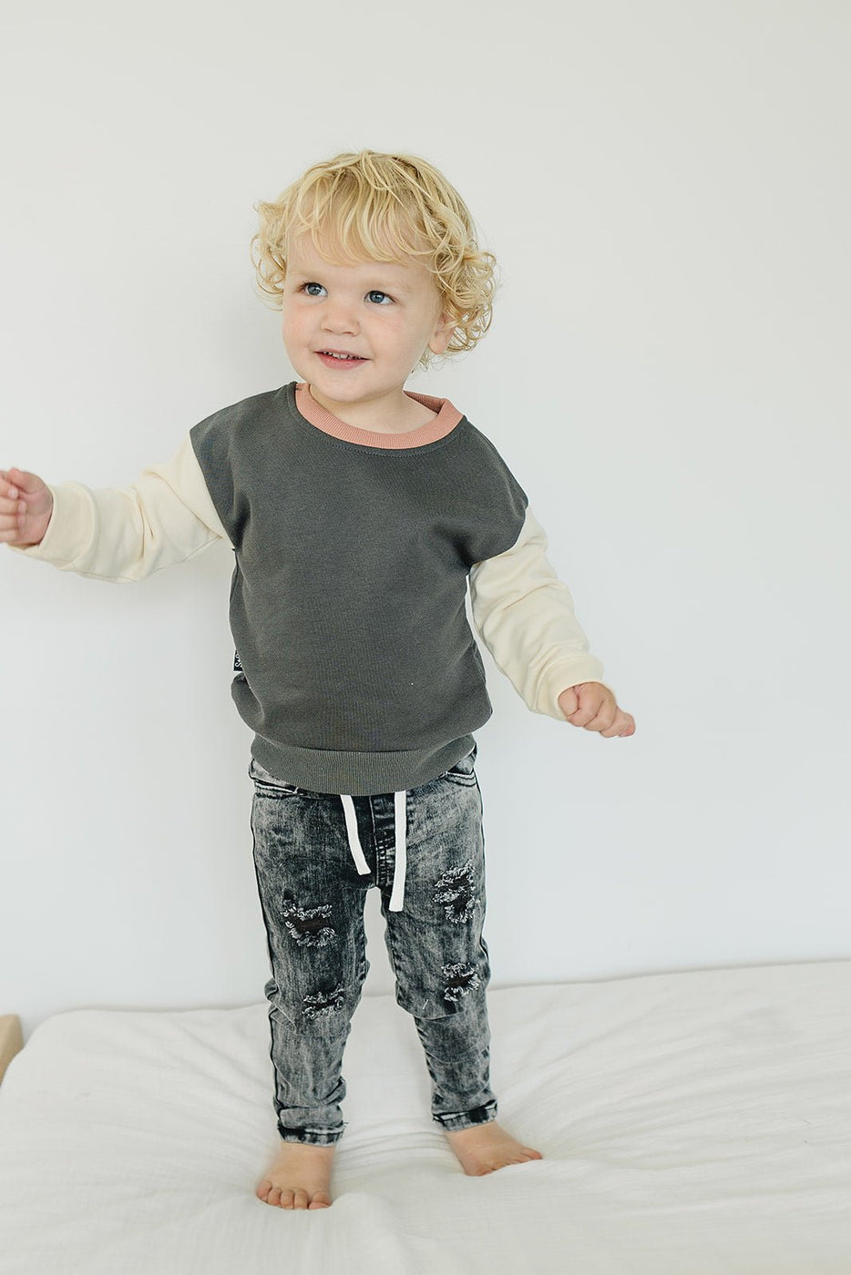 a child standing on a bed