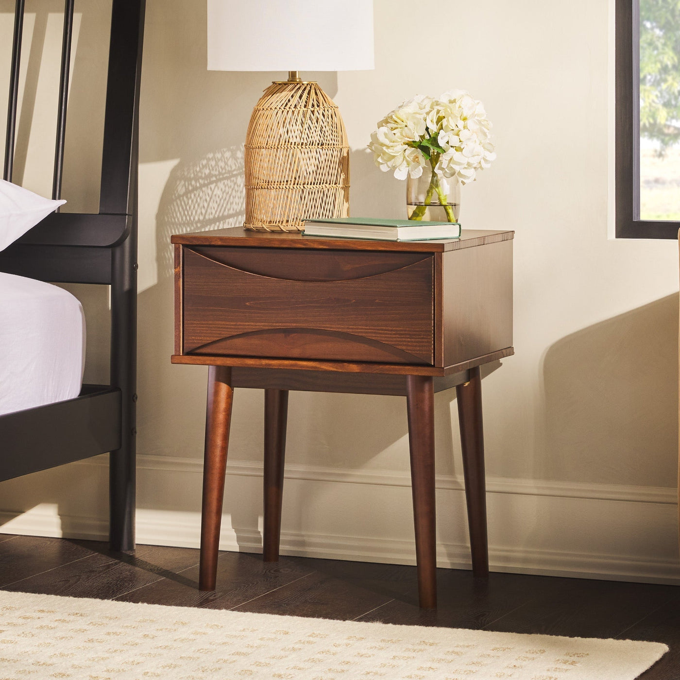 a nightstand next to a bed