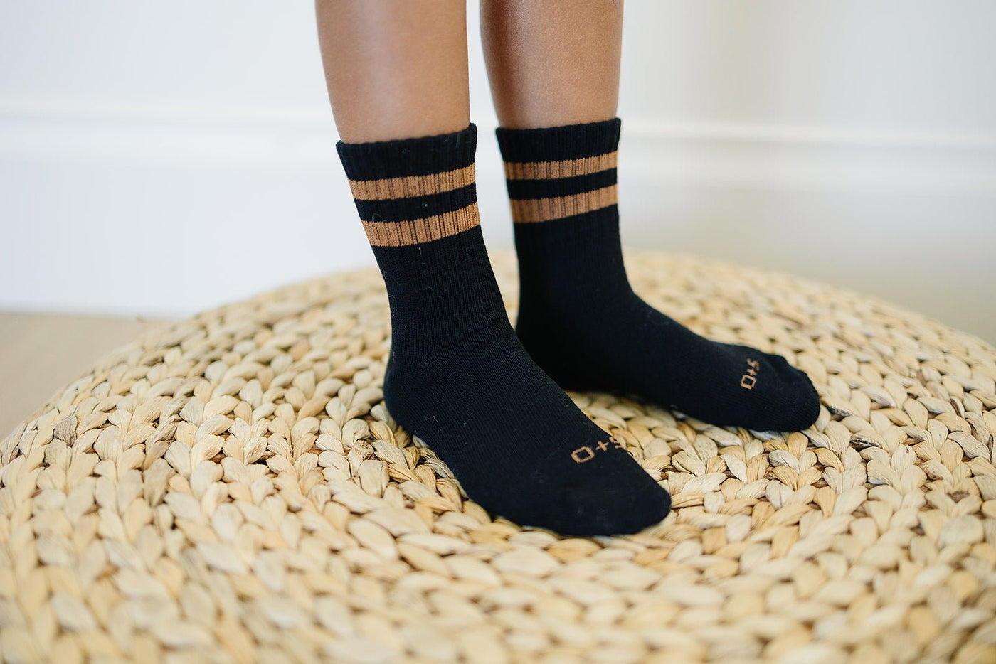 a person's feet wearing black socks