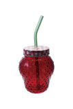 Red perforated tumbler with a green straw on a white background