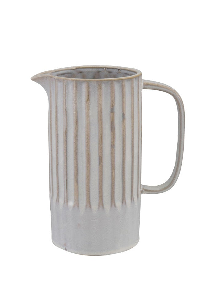 Ceramic pitcher with striped design on a white background