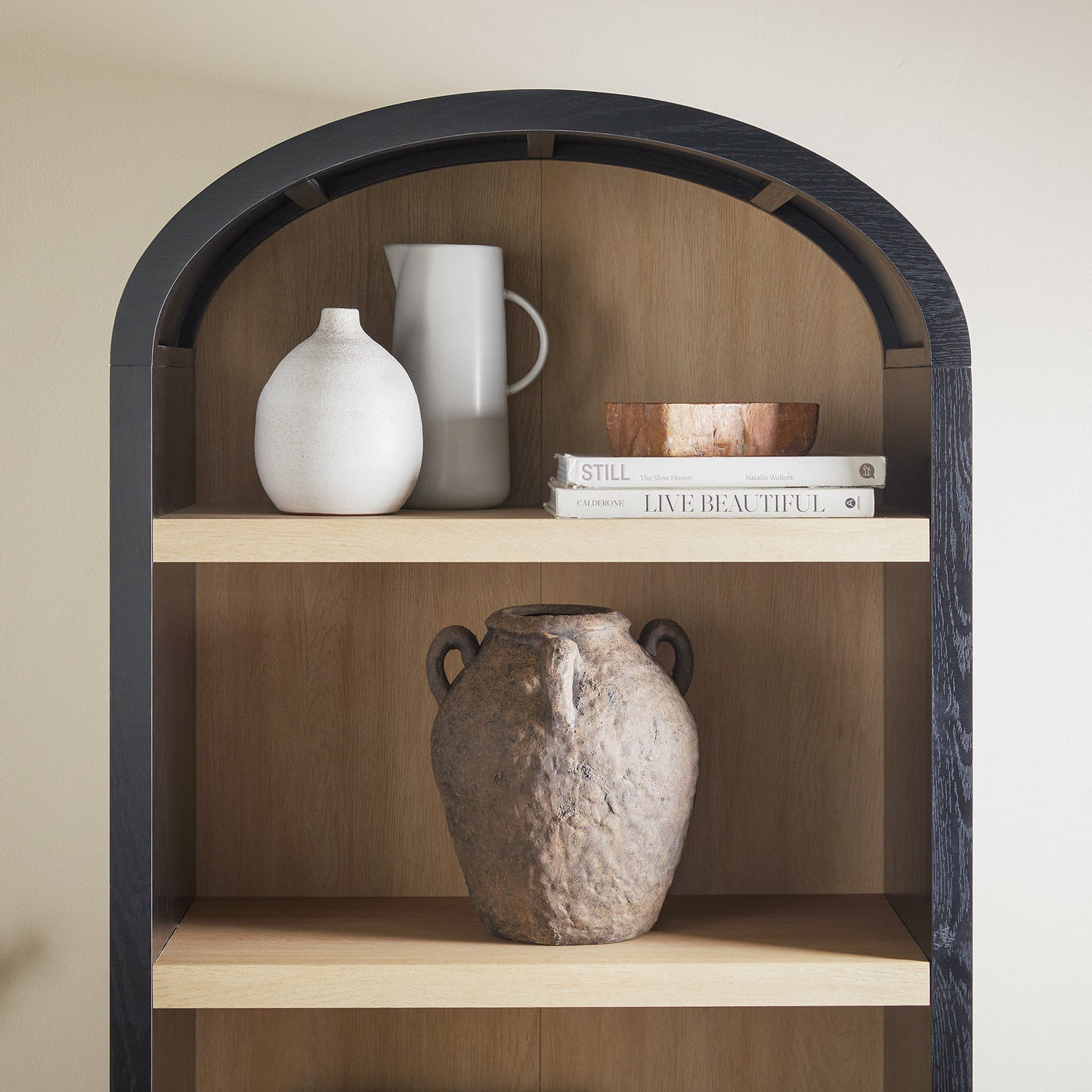 a shelf with vases and books