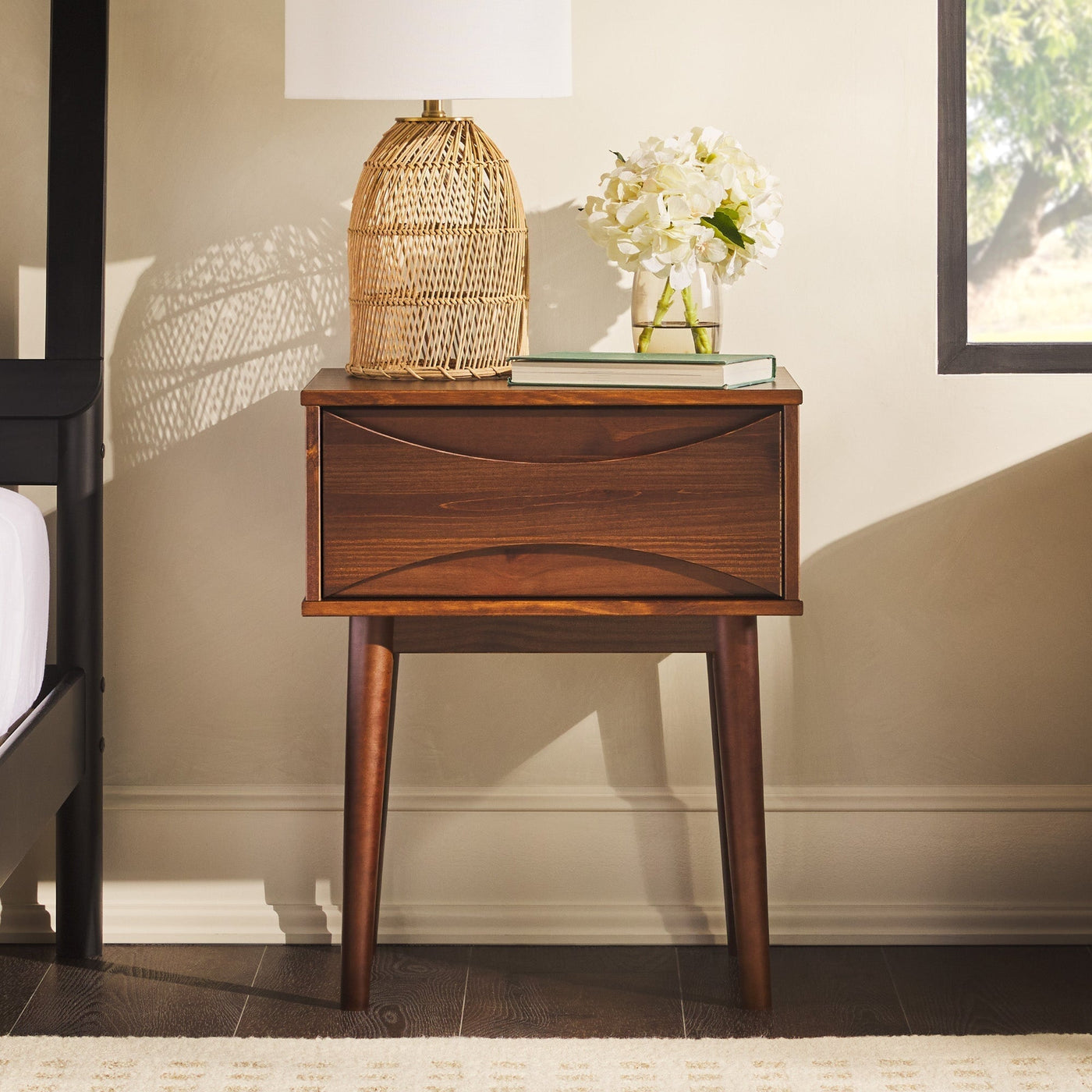 a table with a lamp and flowers on it