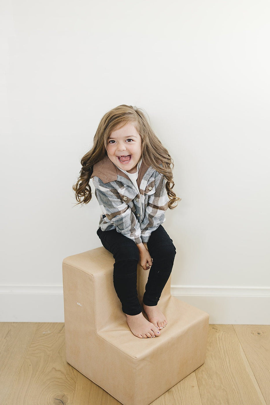 a girl sitting on a box