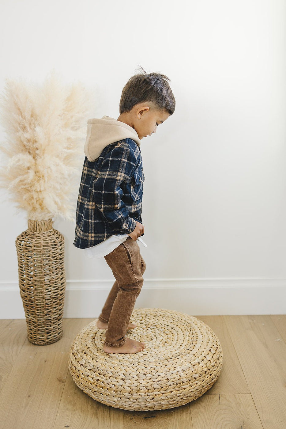 a boy standing on a round basket