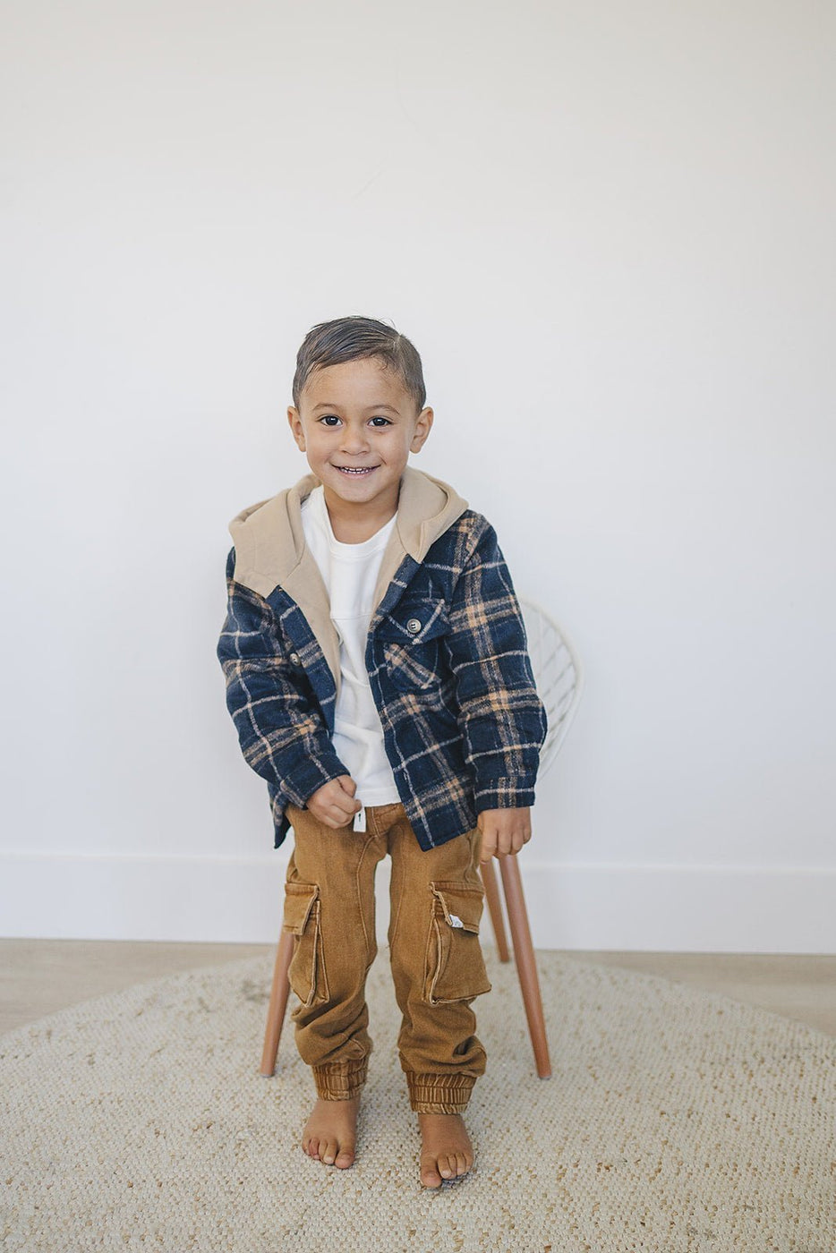 a boy standing in a chair