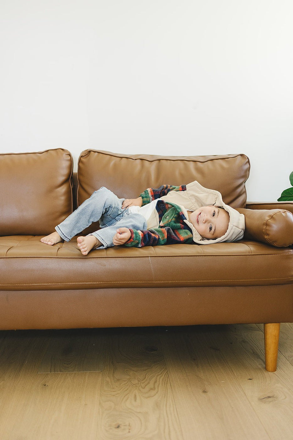 a child lying on a couch