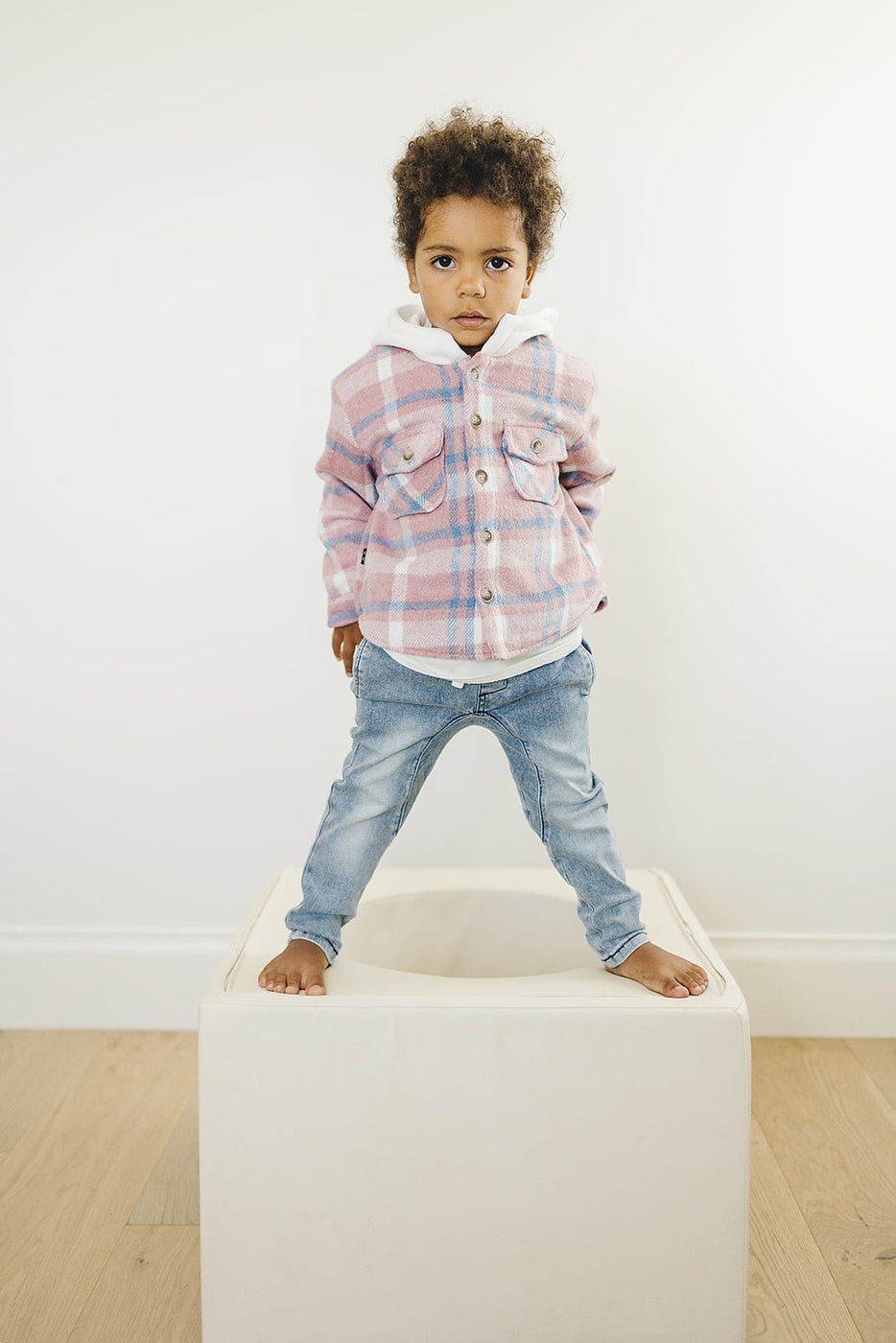 a child standing on a cube