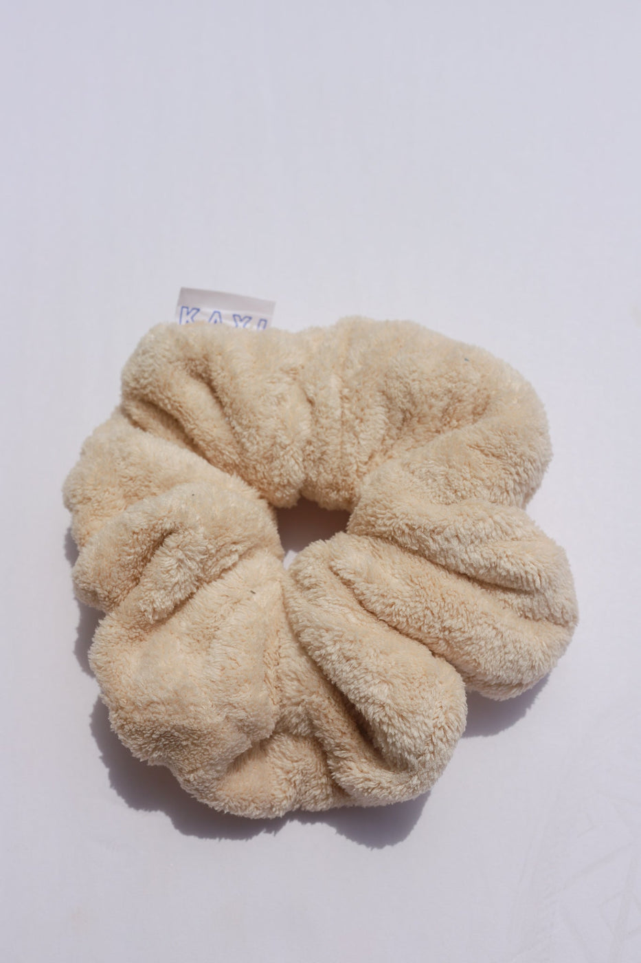 a scrunchie on a white surface