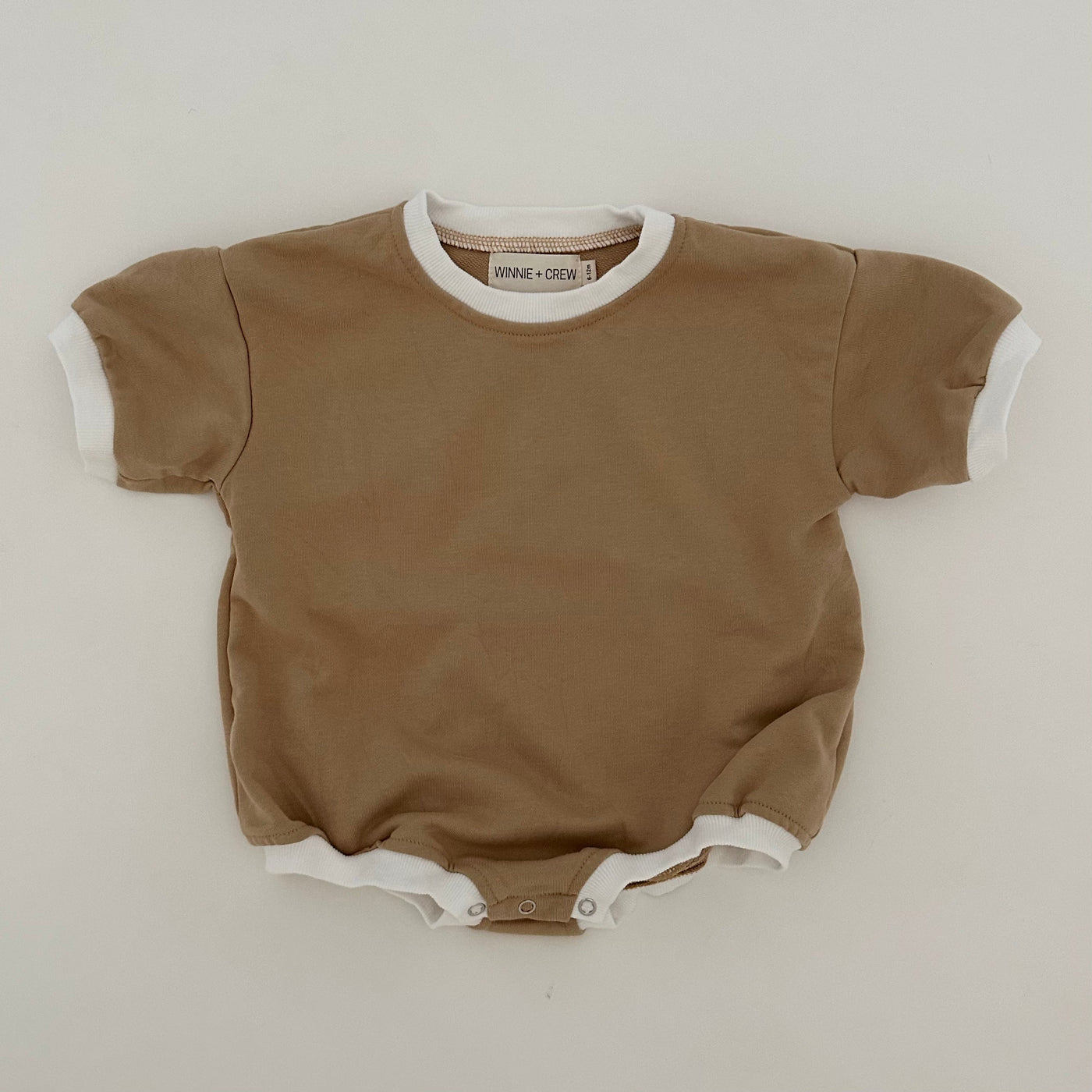 a brown and white baby bodysuit