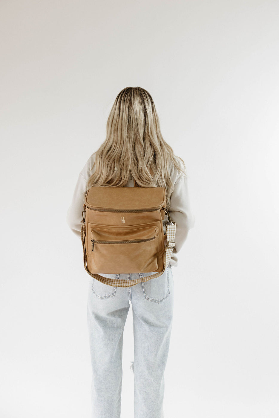 a woman with a brown backpack
