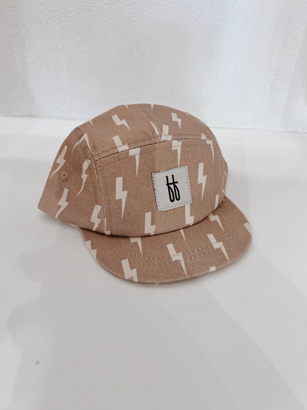 a brown baseball cap with lightning bolts on it