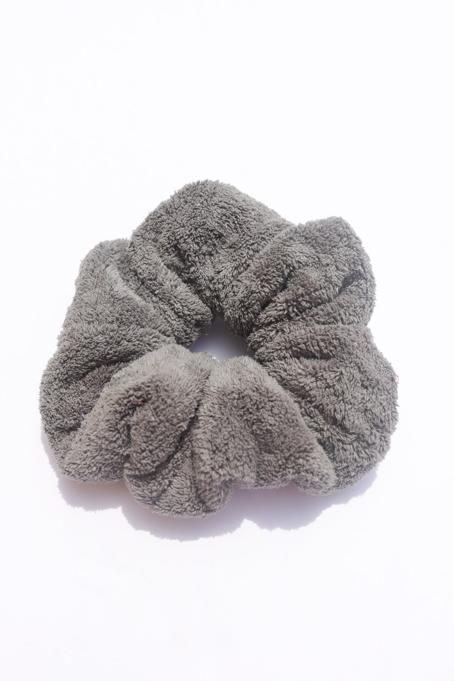a gray hair scrunchie on a white background