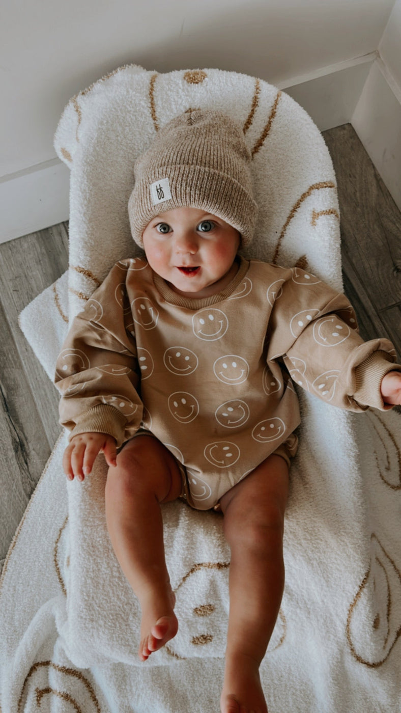 a baby wearing a hat and sweater