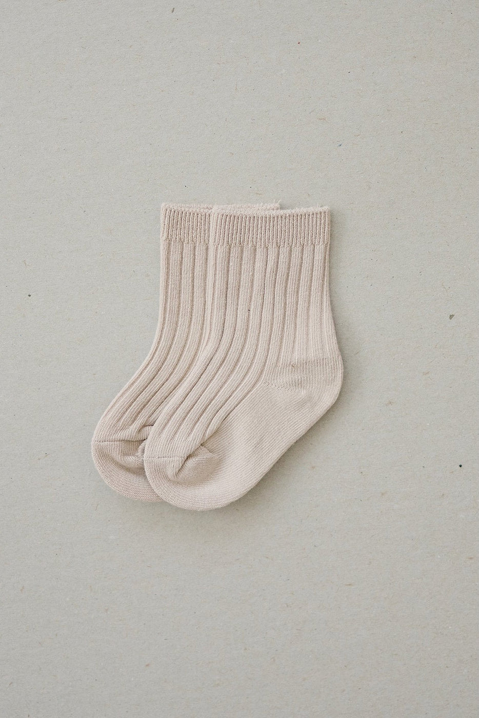a pair of socks on a white surface