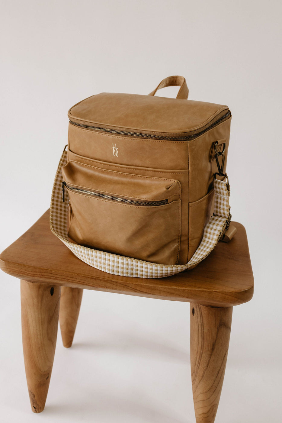 a brown bag on a wooden stool