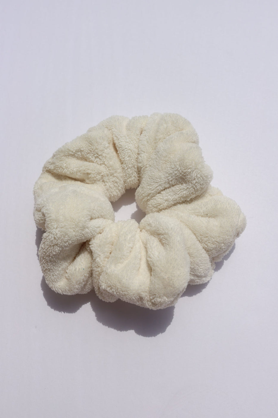 a white hair scrunchie on a white surface