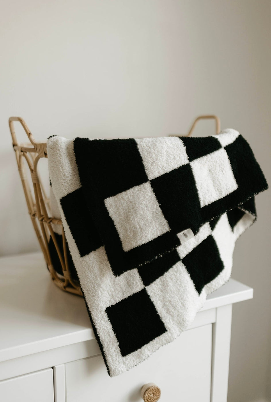 a black and white checkered blanket on a basket
