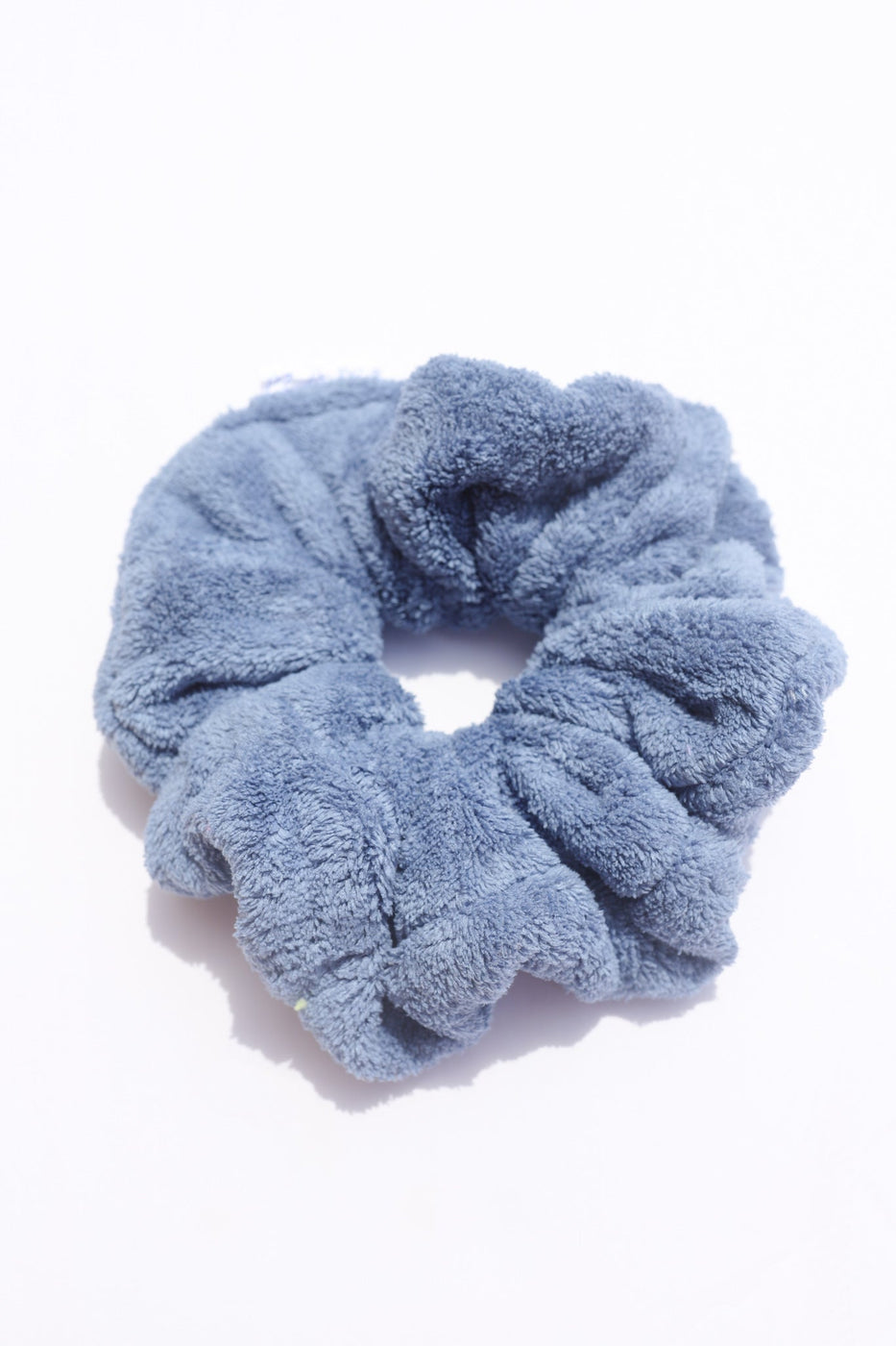 a blue hair scrunchie on a white background