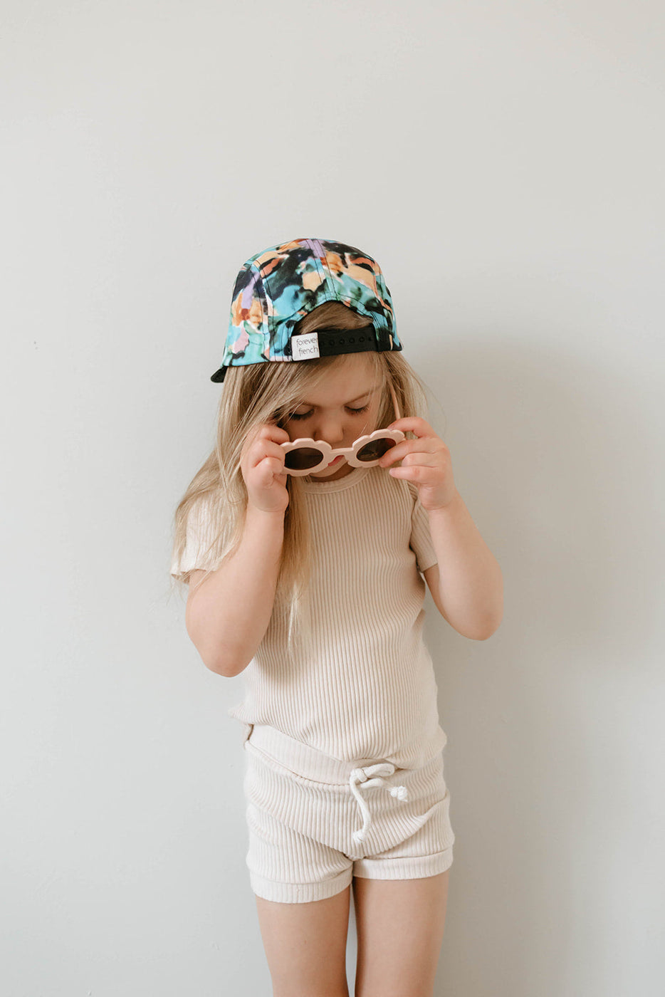 a girl wearing a hat and sunglasses