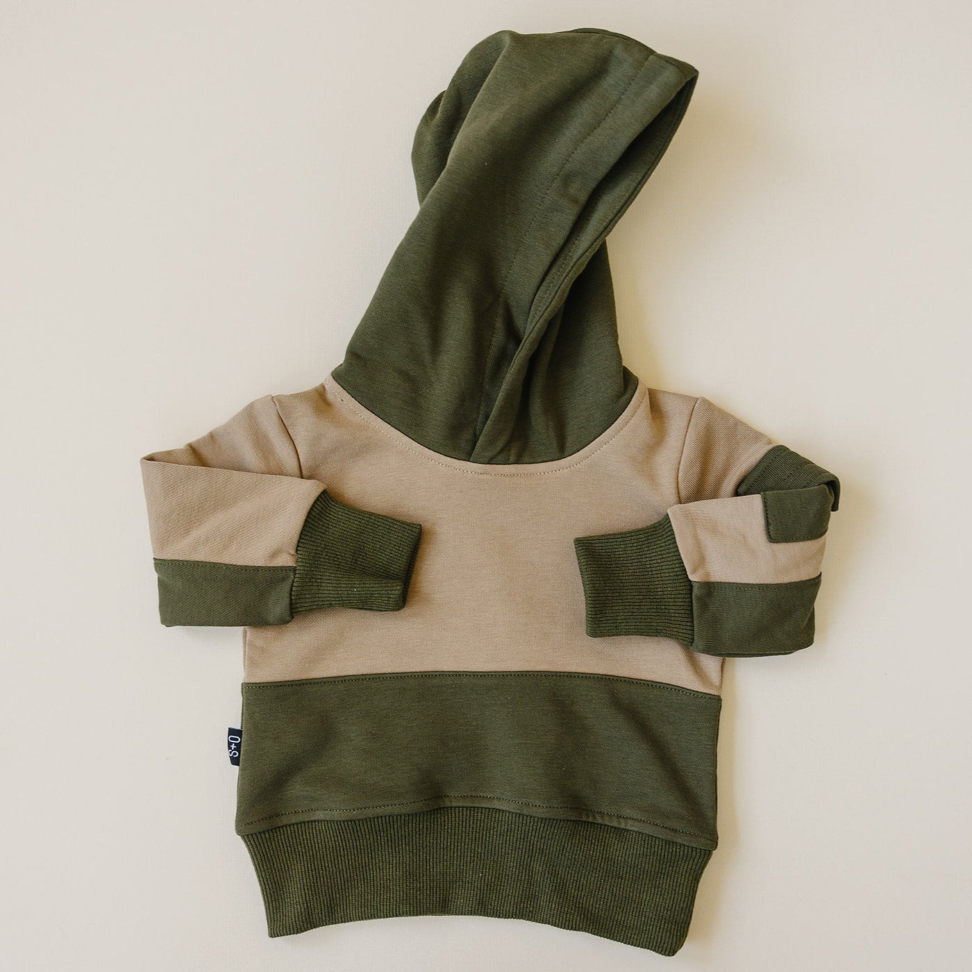 a green and tan sweater with a hood