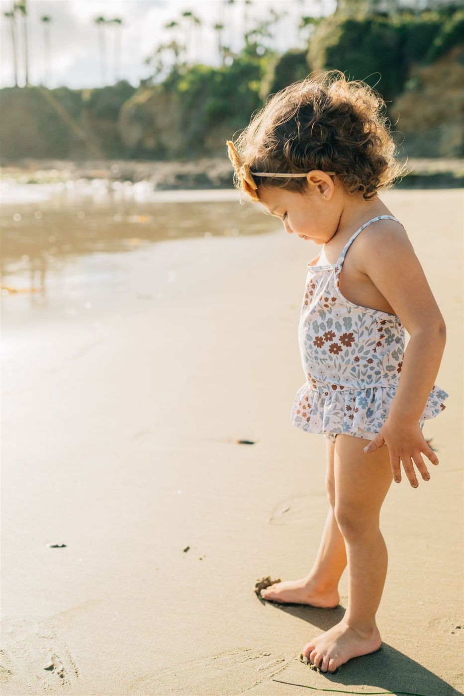 a girl standing on a beach