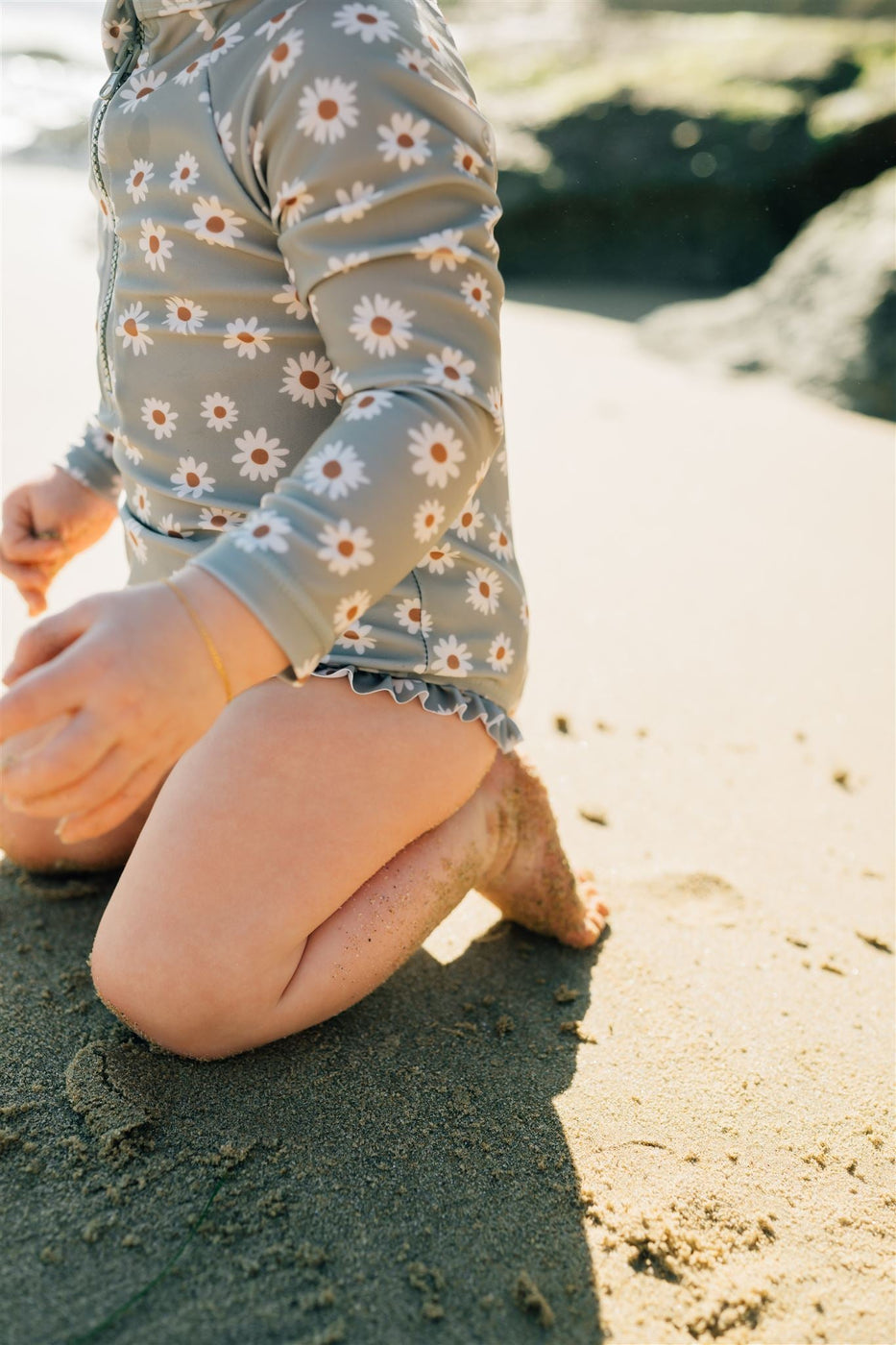 a child's legs in sand