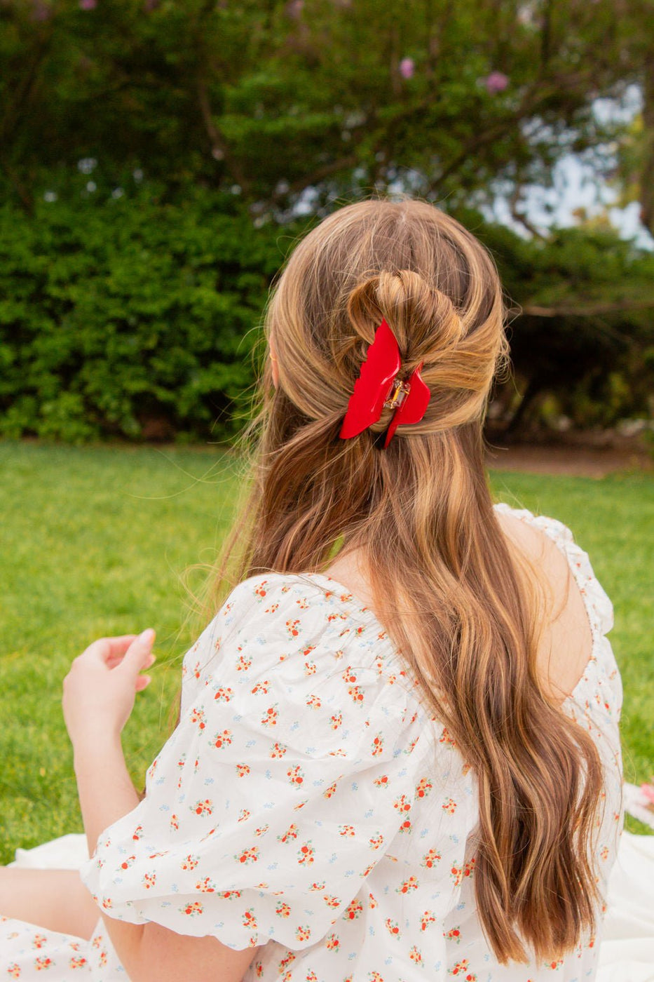 a girl with a red butterfly in her hair