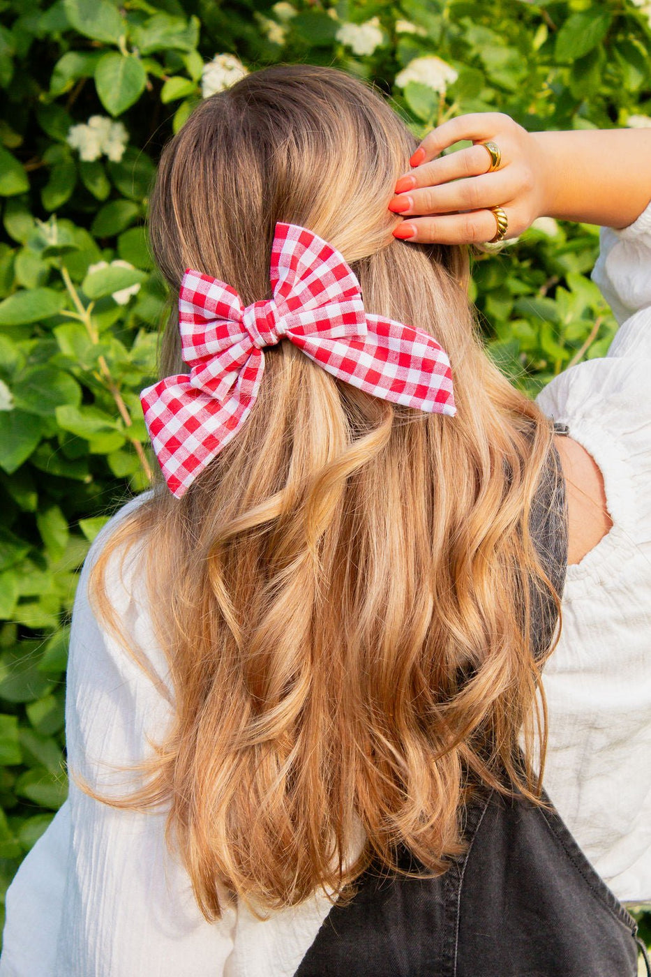 a woman with a red and white bow in her hair