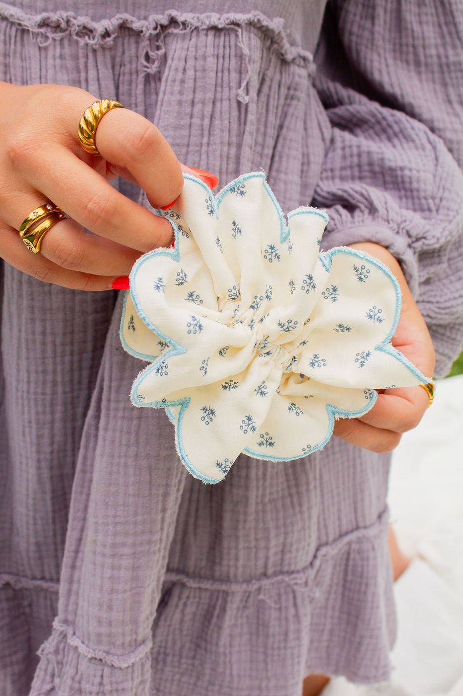 a person holding a fabric flower