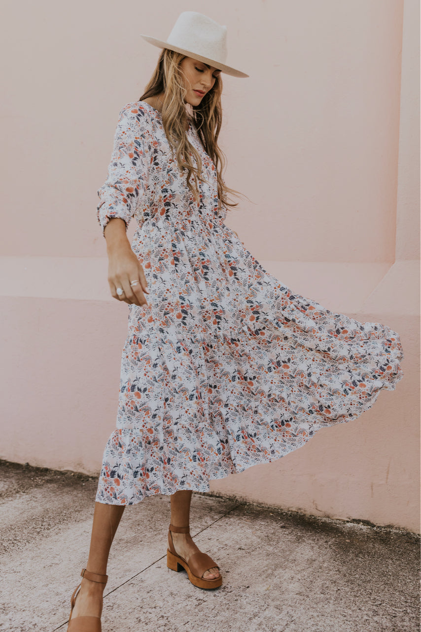 a woman wearing a dress and smiling