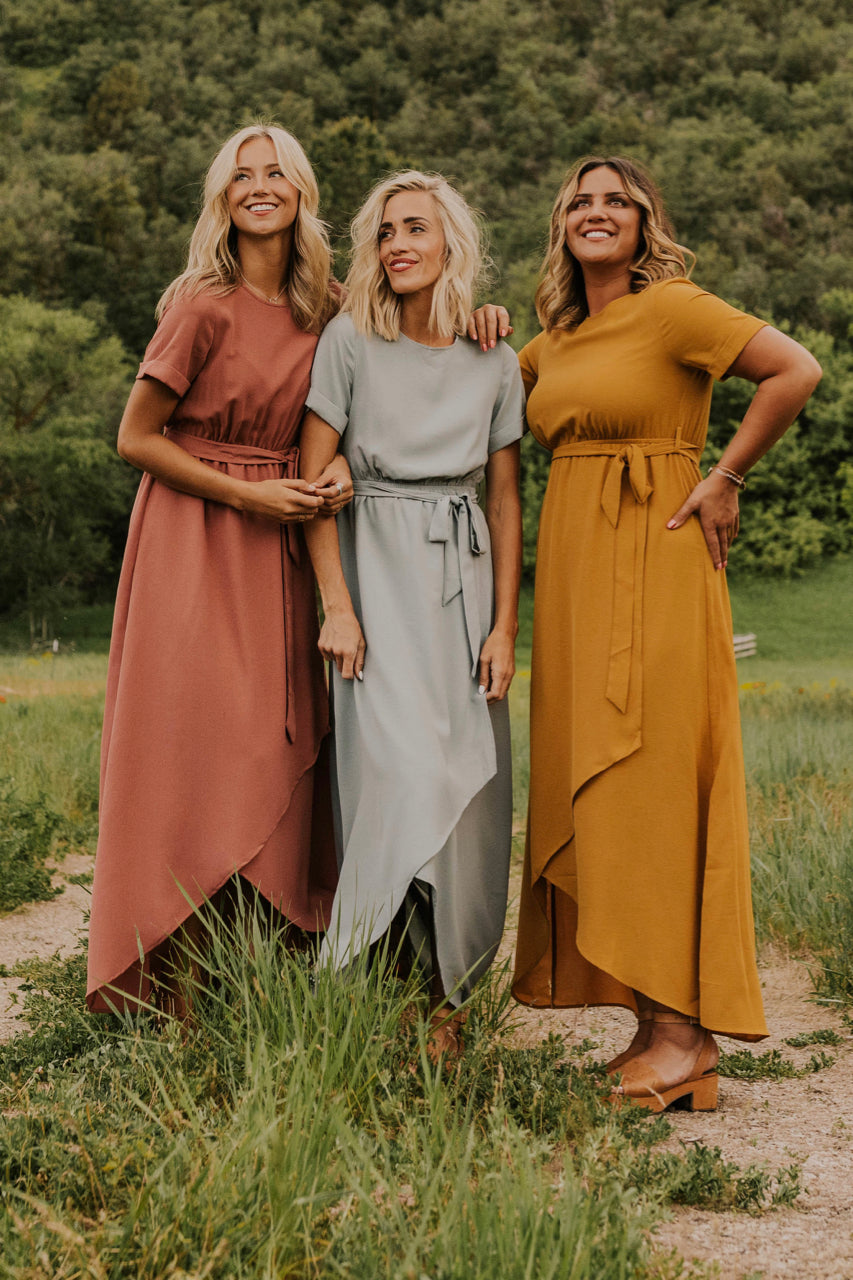 a group of women in dresses posing for a picture