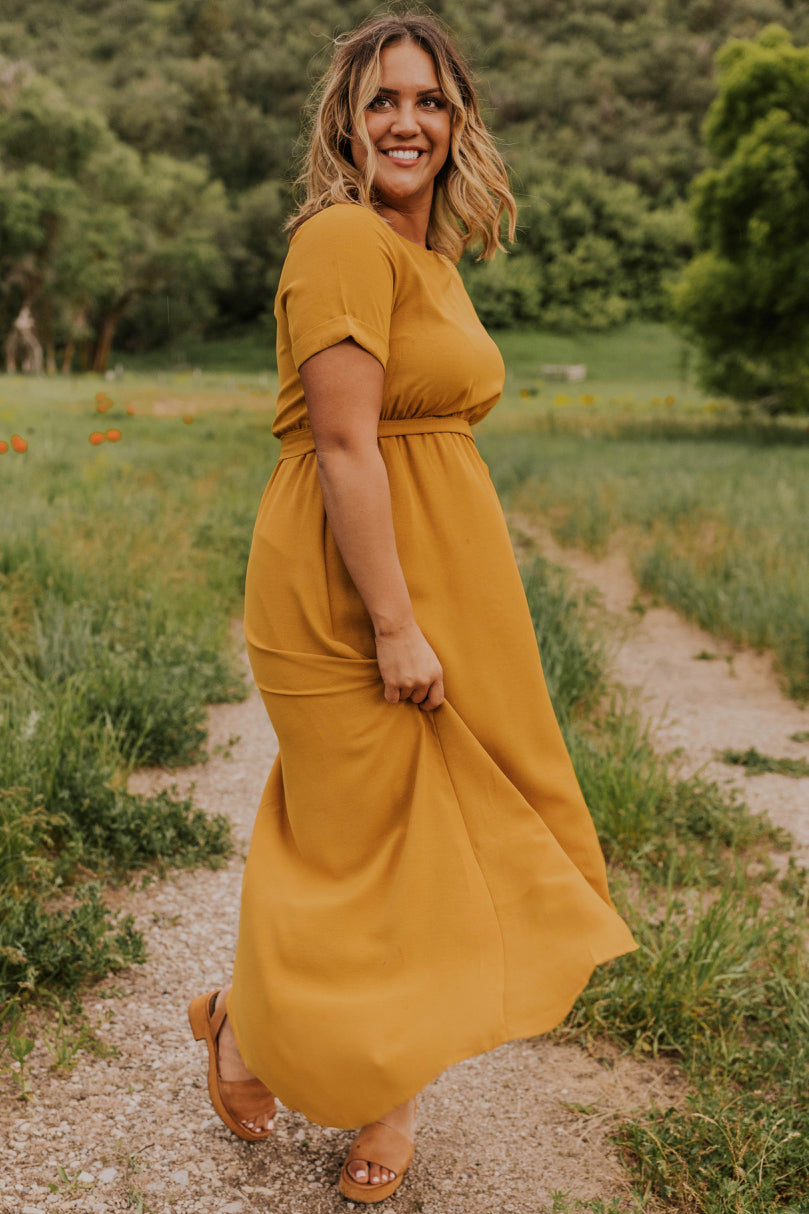 a woman in a yellow dress