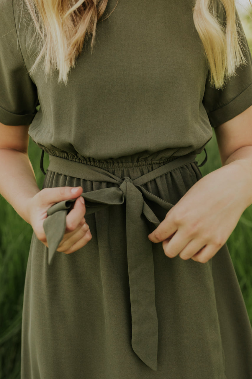 a woman wearing a green dress