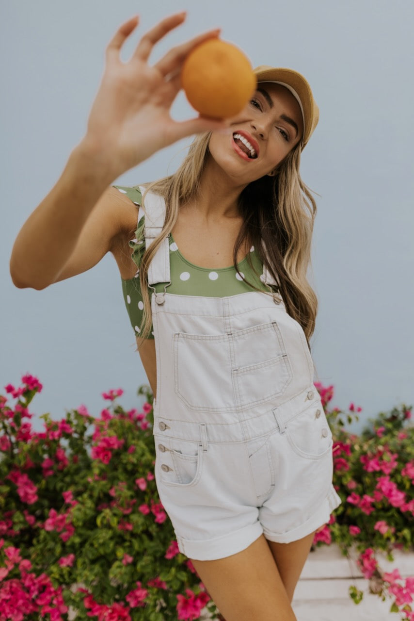 a woman holding an orange