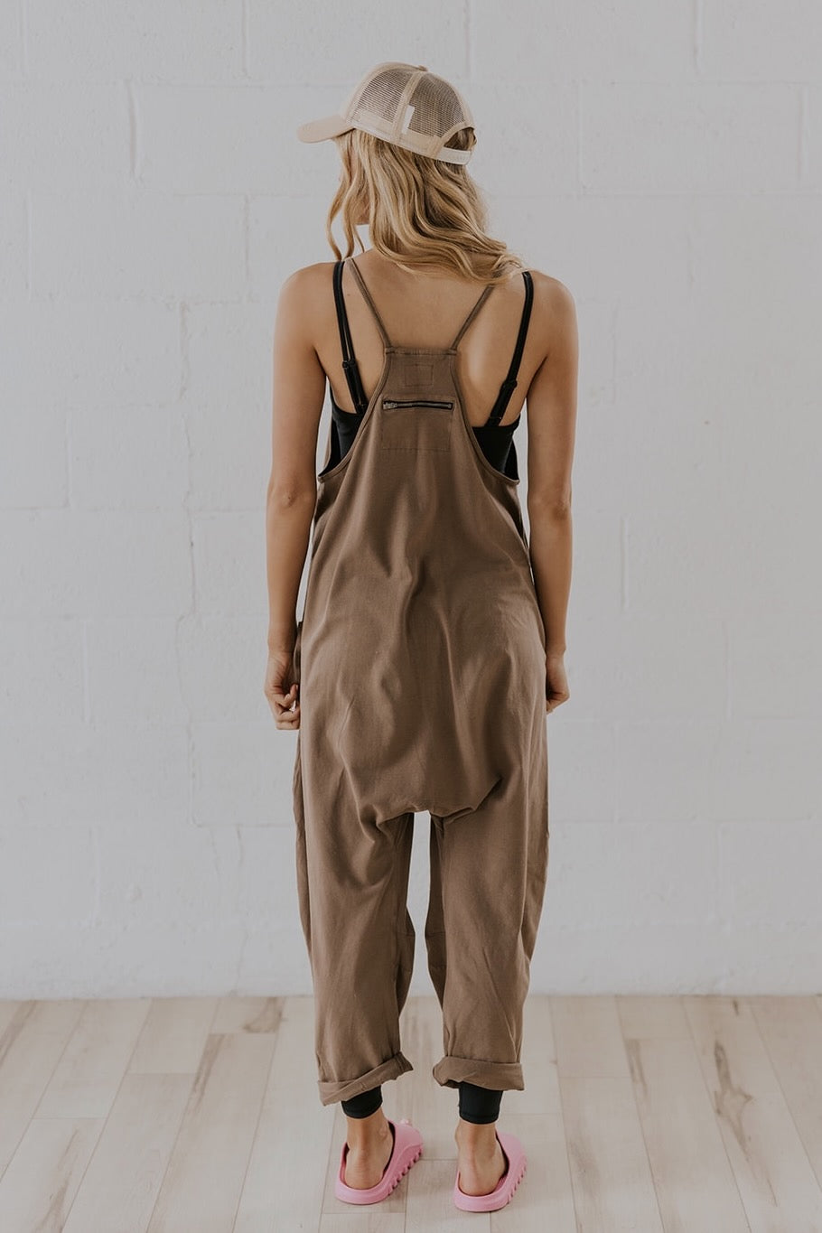 a woman in overalls looking back