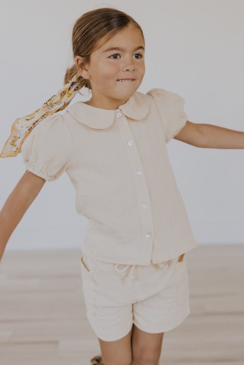 a girl wearing a white shirt and pants