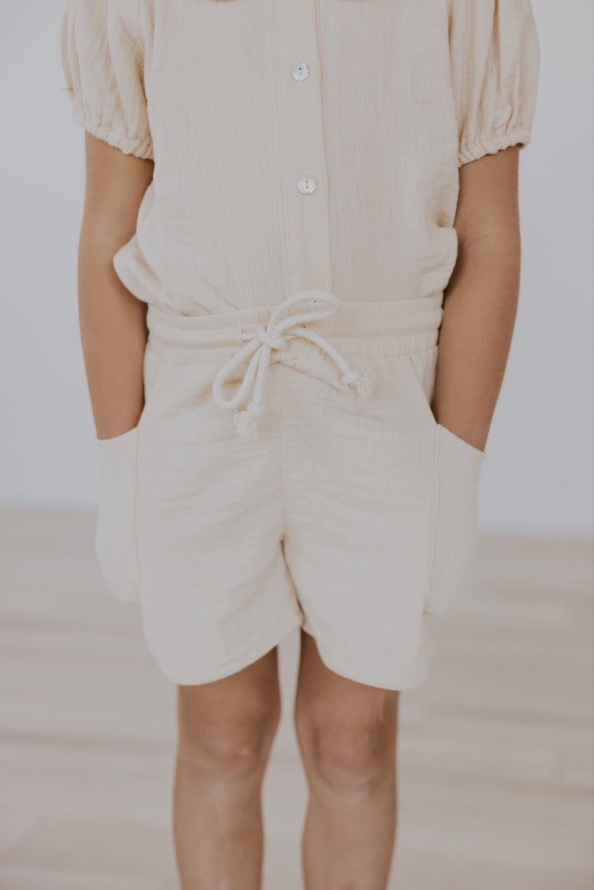 a child wearing a white outfit