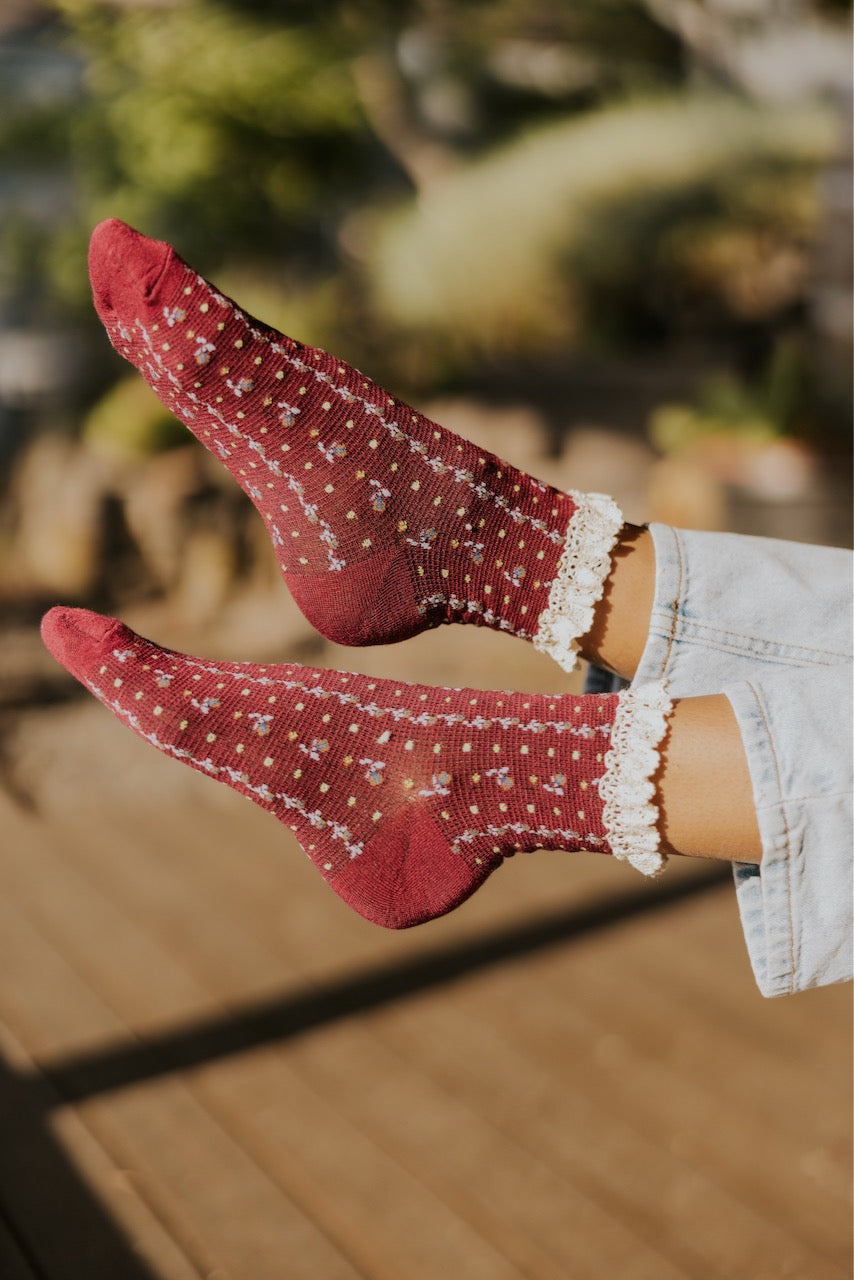 a person's feet in a red socks