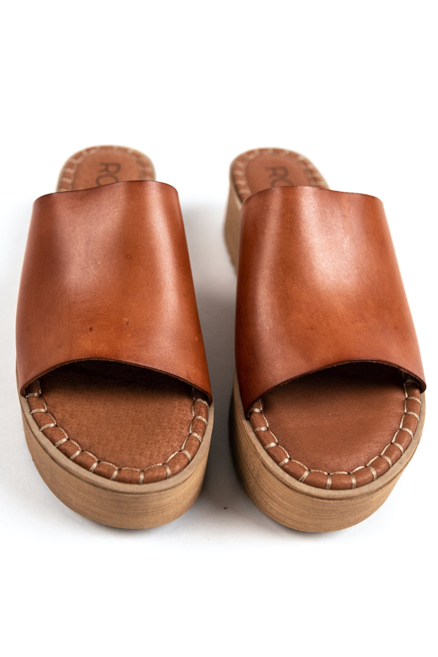 a pair of brown leather sandals
